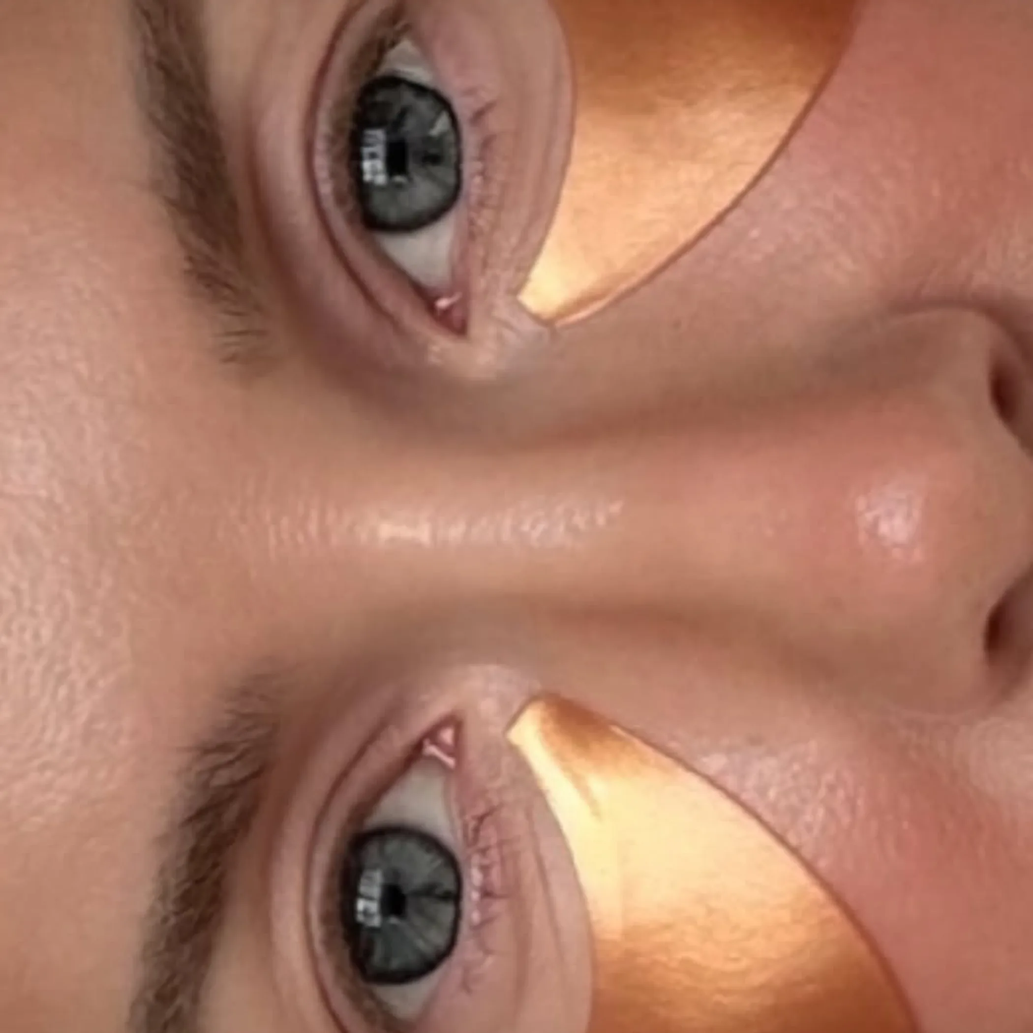 woman applying eye patches skincare